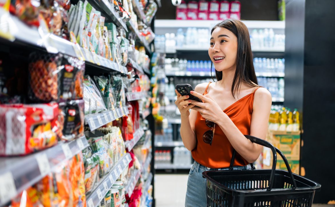 Asian,Young,Beautiful,Woman,Holding,Grocery,Basket,Walk,In,Supermarket.